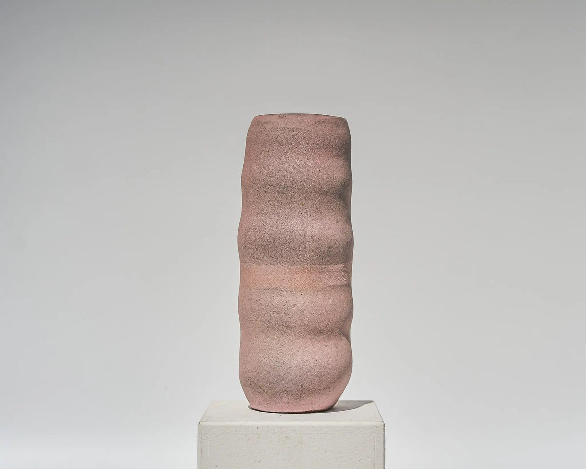 the circle turns, a matte rosé stoneware vase with a wave around its body, by atelier von ehren