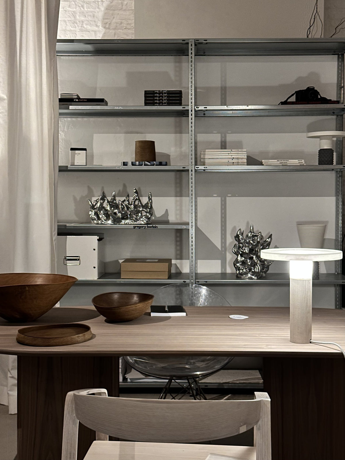 shelving and table with lamp and bowls, spazio Munich