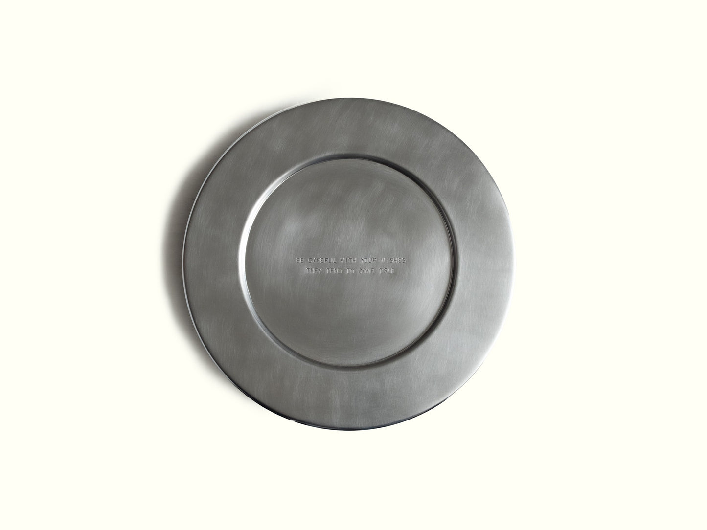 traces charging plate 'wishes' — brushed aluminium, engraved 'be careful with your wishes, they tend to come true' · studio von schoenebeck · collectible design at spazio